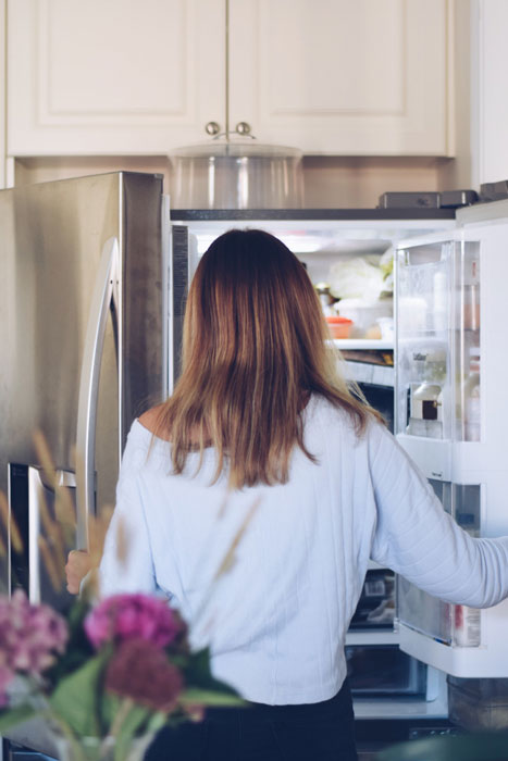 young-teenage-girl-is-taking-food-from-refrigerator